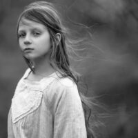 A parent gently supporting a sensitive child in a calm and safe environment