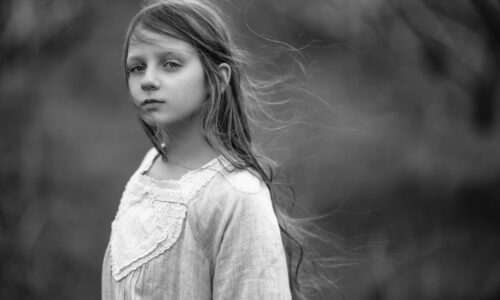 A parent gently supporting a sensitive child in a calm and safe environment